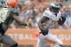 Philadelphia Eagles running back LeSean McCoy (25) of Team Rice runs past Carolina Panthers linebacker Luke Kuechly, left, and Cleveland Browns safety T.J. Ward (43) of Team Sanders in the second quarter quarter of the NFL Pro Bowl football game Sunday, Jan. 26, 2014, in Honolulu. (AP Photo/Eugene Tanner)