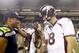 Aug 17, 2013; Seattle, WA, USA; Seattle Seahawks quarterback Russell Wilson (3) and Denver Broncos quarterback Peyton Manning (18) speak following a 40-10 preseason victory by the Seahawks at CenturyLink Field. Mandatory Credit: Joe Nicholson-USA TODAY Sports