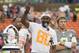 Hall of Famer Jerry Rice, Pro Bowl alumni team captain, thanks the fans for supporting the Pro Bowl football game, Sunday, Jan. 26, 2014, in Honolulu. Kansas City Chiefs linebacker Derrick Johnson, back left, of Team Rice, the defensive most valuable player and Philadelphia Eagles quarterback Nick Foles, back right, of Team Sanders look on during Rice's speech. Team Rice defeated Team Sanders 22-21. (AP Photo/Eugene Tanner)