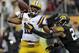 LSU quarterback Anthony Jennings (10) throws a pass as he gets hit by Iowa linebacker Christian Kirksey (20) during the first quarter of the Outback Bowl NCAA college football game Wednesday, Jan. 1, 2014, in Tampa, Fla. (AP Photo/Chris O'Meara)