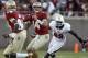Florida State quarterback Jacob Coker (14) looks for a receiver before being sacked by North Carolina State defensive end Darryl Cato-Bishop (92) in the third quarter of an NCAA college football game on Saturday, Oct. 26, 2013, in Tallahassee, Fla. Florida State won 49-17. (AP Photo/Phil Sears)