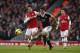 Arsenal's Mikel Arteta, left, competes for the ball with Southampton's Jay Rodriguez during the English Premier League soccer match between Arsenal and Southampton at the Emirates Stadium in London, Saturday, Nov. 23, 2013. (AP Photo/Matt Dunham)