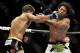 Josh Thomson, left, punches Benson Henderson right, during the main event of a UFC mixed martial arts event in Chicago, Saturday, Jan. 25, 2014. (AP Photo/Paul Beaty)