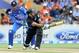 New Zealand's Ross Taylor, right, pulls a ball to the boundary in front of India’s MS Dhoni in the second one-day International cricket match at Seddon Park in Hamilton, New Zealand, Wednesday, Jan. 22, 2014. (AP Photo/SNPA, Ross Setford) NEW ZEALAND OUT