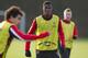 Manchester United's Wilfried Zaha, centre, trains with teammates at Carrington training ground in Manchester, Monday, Dec. 9, 2013. Manchester United will play Shakhtar Donetsk in a Champion's League Group A soccer match on Tuesday. (AP Photo/Jon Super)
