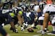 Seattle Seahawks' Jesse Williams (90) lines up with teammates at the line of scrimmage against the Denver Broncos in the second half of a preseason NFL football game, Saturday, Aug. 17, 2013, in Seattle. (AP Photo/John Froschauer)