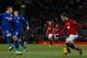 Manchester United's Juan Mata, right, keeps the ball from Cardiff City's Gary Medel, left, and Craig Noone, second left, during their English Premier League soccer match at Old Trafford Stadium, Manchester, England, Tuesday Jan. 28, 2014. (AP Photo/Jon Super)