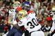 Arizona's Ka'Deem Carey, behind, drives to the endzone for a touchdown while UCLA's Myles Jack (30) holds on in the first half of an NCAA college football game, Saturday, Nov. 9, 2013 in Tucson, Ariz. (AP Photo/Wily Low)