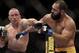 Johny Hendricks, right, exchanges punches with Georges St. Pierre, of Canada, during a UFC 167 mixed martial arts championship welterweight bout on Saturday, Nov. 16, 2013, in Las Vegas. St. Pierre won by split decision. (AP Photo/Isaac Brekken)