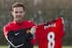 Manchester United's new signing Juan Mata displays his new shirt before a press conference at the team's Carrington training ground, Manchester, England, Monday, Jan. 27, 2014. With Manchester United in danger of missing out on the Champions League next season, Juan Mata's arrival at Old Trafford for a club record fee of 37.1 million pounds ($61.2 million) is certainly an emergency move. But it also marks the first step in the rebuilding process of England's most titled club. After a botched transfer campaign last summer that was followed by the club's lackluster first half of the season, United now looks determined to allow manager David Moyes the opportunity to build his own team.(AP Photo/Jon Super)