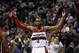 Washington Wizards guard John Wall (2) celebrates in the second half of an NBA basketball game against the Miami Heat, Wednesday, Jan. 15, 2014, in Washington. The Wizards won 114-97. (AP Photo/Alex Brandon)