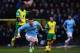 NORWICH, ENGLAND - FEBRUARY 08: Alexander Tettey of Norwich City tackles Aleksandar Kolarov of Manchester City from behind during the Barclays Premier League match between Norwich City and Manchester City at Carrow Road on February 8, 2014 in Norwich, England. (Photo by Jamie McDonald/Getty Images)