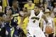 Iowa guard Devyn Marble, right, looks to drive past Michigan guard Caris LeVert (23) during the first half of an NCAA college basketball game, Saturday, Feb. 8, 2014, in Iowa City, Iowa. (AP Photo/Charlie Neibergall)