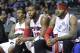 Detroit Pistons guard Brandon Jennings, from left, center Greg Monroe and forward Josh Smith watch their game against the Brooklyn Nets from the bench during the second half of an NBA basketball game Friday, Feb. 7, 2014, in Auburn Hills, Mich. (AP Photo/Duane Burleson)