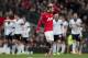Manchester United's Juan Mata wipes his hair as Fulham players celebrate their first goal, scored by Steve Sidwell, during their English Premier League soccer match at Old Trafford Stadium, Manchester, England, Sunday Feb. 9, 2014. (AP Photo/Jon Super)