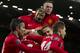 Manchester United's Michael Carrick, bottom centre left, celebrates with jubilant teammates after scoring against Fulham during their English Premier League soccer match at Old Trafford Stadium, Manchester, England, Sunday Feb. 9, 2014. (AP Photo/Jon Super)