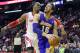 Los Angeles Lakers' Pau Gasol (16) goes to the basket with Houston Rockets' Dwight Howard at his back in the first half of an NBA basketball game on Wednesday, Jan. 8, 2014, in Houston. (AP Photo/Pat Sullivan)