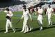 New Zealand’s Brendon McCullum, center, walks with his team after their 40 run defeat of India on the fourth day of the first cricket test at Eden Park in Auckland, New Zealand, Sunday, Feb. 9, 2014. (AP Photo/SNPA, Ross Setford) NEW ZEALAND OUT