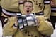Boston College goalie Parker Milner raises the Beanpot trophy after defeating Northeastern 6-3 to win the championship game at the Beanpot college hockey tournament in Boston, Monday, Feb. 11, 2013. (AP Photo/Charles Krupa)