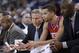 Philadelphia 76ers head coach Brett Brown, left, talks to point guard Michael Carter-Williams, center, in the closing minutes of a 123-80 loss to the Golden State Warriors during the second half of an NBA basketball game on Monday, Feb. 10, 2014, in Oakland, Calif. (AP Photo/Marcio Jose Sanchez)