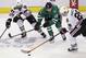 Dallas Stars right wing Alex Chiasson (12) skates for the puck against Chicago Blackhawks center Michal Handzus (26) and defenseman Johnny Oduya (27) during the first period of an NHL hockey game Friday, Nov. 29, 2013, in Dallas. (AP Photo/LM Otero)
