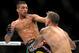 Charles Oliveira, left, and Frankie Edgar battle during their UFC 162 mixed martial arts featherweight bout at the MGM Grand Garden Arena on Saturday, July 6, 2013, in Las Vegas. Edgar won the three round fight with a unanimous decision. (AP Photo/David Becker)