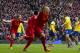 Liverpool's Martin Skrtel, centre, celebrates after scoring against Arsenal during their English Premier League soccer match at Anfield Stadium, Liverpool, England, Saturday Feb. 8, 2014. (AP Photo/Jon Super)
