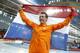 Stefan Groothuis of the Netherlands holds his national flag and celebrates after winning the gold in the men's 1,000-meter speedskating race at the Adler Arena Skating Center at the 2014 Winter Olympics in Sochi, Russia, Wednesday, Feb. 12, 2014.(AP Photo/Pavel Golovkin)