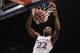 Nov 22, 2013; Lawrence, KS, USA; Kansas Jayhawks guard Andrew Wiggins (22) dunks the ball as Towson Tigers forward John Davis (10) defends during the first half of the game at Allen Fieldhouse. Mandatory Credit: Denny Medley-USA TODAY Sports