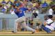 New York Mets' Juan Lagares follows through on a solo home run as Los Angeles Dodgers catcher A.J. Ellis and home plate umpire Jeff Kellogg watch during the first inning of a baseball game, Tuesday, Aug. 13, 2013, in Los Angeles. (AP Photo/Mark J. Terrill)