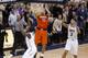 Syracuse's Tyler Ennis (11) shoots 3-pointer between Pittsburgh's Cameron Wright (3) and Josh Newkirk, left, in the final second of an NCAA college basketball game Wednesday, Feb. 12, 2014, in Pittsburgh. The shot went in and Syracuse won 58-56. (AP Photo/Keith Srakocic)
