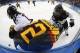 Yuka Hirano (17) and Tomoko Sakagami (18) of Japan battle up against the boards with Kerstin Spielberger of Germany during the 2014 Winter Olympics women's ice hockey game at Shayba Arena, Thursday, Feb. 13, 2014, in Sochi, Russia. (AP Photo/Petr David Josek)
