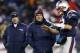 Nov 24, 2013; Foxborough, MA, USA; New England Patriots quarterback Tom Brady (12) talks with head coach Bill Belichick (middle) and offensive coordinator Josh McDaniels during warm-ups before the game against the Denver Broncos at Gillette Stadium Stadium. Mandatory Credit: Greg M. Cooper-USA TODAY Sports
