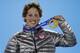 Men's slopestyle skiing gold medalist Joss Christensen of the United States smiles while holding his medal during the medals ceremony at the 2014 Winter Olympics, Thursday, Feb. 13, 2014, in Sochi, Russia. (AP Photo/David Goldman)