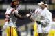 USC tight end Xavier Grimble (86) celebrates a touchdown with head coach Lane Kiffin during the first half of an NCAA football game against Colorado in Boulder, Colo., Friday, Nov. 4, 2011. (AP Photo/Jack Dempsey)