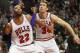 Chicago Bulls forward Taj Gibson, left, and Chicago Bulls forward Mike Dunleavy, right, protect the basket against Detroit Pistons forward Josh Smith, center, during an NBA basketball game in Chicago, Saturday, Dec. 7, 2013. The Pistons defeated the Bulls 92-75. (AP Photo/Kamil Krzaczynski)