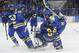 Team Sweden celebrates this 4-2 victory over Finland during the 2014 Winter Olympics women's ice hockey quarterfinal game at Shayba Arena, Saturday, Feb. 15, 2014, in Sochi, Russia. (AP Photo/Petr David Josek)