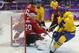 Sweden forward Daniel Alfredsson scores a goal against Switzerland goaltender Reto Berra in the third period of a men's ice hockey game at the 2014 Winter Olympics, Friday, Feb. 14, 2014, in Sochi, Russia. (AP Photo/Mark Humphrey)