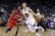 Golden State Warriors' Stephen Curry (30) dribbles next to Philadelphia 76ers' Elliot Williams (25) during the second half of an NBA basketball game on Monday, Feb. 10, 2014, in Oakland, Calif. (AP Photo/Marcio Jose Sanchez)