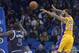Los Angeles Lakers point guard Kendall Marshall (12) passes the ball over Orlando Magic power forward Kyle O'Quinn (2) and shooting guard Victor Oladipo (5) during the second half of an NBA basketball game in Orlando, Fla., Friday, Jan. 24, 2014. The Magic won 114-105.(AP Photo/Phelan M. Ebenhack)