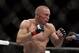 Georges St. Pierre, of Canada, fights Johny Hendricks during a UFC 167 mixed martial arts championship welterweight bout on Saturday, Nov. 16, 2013, in Las Vegas. St. Pierre won by split decision. (AP Photo/Isaac Brekken)