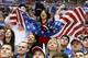US fans cheer a second period goal by the USA against Russia during a men's ice hockey game at the 2014 Winter Olympics, Saturday, Feb. 15, 2014, in Sochi, Russia. (AP Photo/Mark Humphrey)