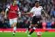 LONDON, ENGLAND - FEBRUARY 16: Raheem Sterling (R) of Liverpool holds off the challenge of Mathieu Flamini (L) of Arsenal during the FA Cup Fifth Round match between Arsenal and Liverpool at the Emirates Stadium on February 16, 2014 in London, England. (Photo by Shaun Botterill/Getty Images)