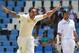 Australia's bowler Mitchell Johnson, left, celebrates his wicket as South Africa's captain Graeme Smith, right, watches on the fourth day of their cricket test match against South Africa at Centurion Park in Pretoria, South Africa, Saturday, Feb. 15, 2014. (AP Photo/ Themba Hadebe)