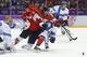 Canada forward Benn Jamie (22) scrambles against Finland defenseman Juuso Hietanen in the first period of a men's ice hockey game at the 2014 Winter Olympics, Sunday, Feb. 16, 2014, in Sochi, Russia. (AP Photo/Mark Humphrey)