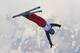China's Qi Guangpu jumps during men's freestyle skiing aerials training at the Rosa Khutor Extreme Park, at the 2014 Winter Olympics, Sunday, Feb. 16, 2014, in Krasnaya Polyana, Russia. (AP Photo/Sergei Grits)