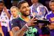 Kyrie Irving hoisting the MVP trophy of the 2014 All-Star game.