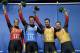 The German team of Natalie Geisenberger, in orange, Felix Loch, in blue, and doubles team of Tobias Wendl and Tobias Arlt, in yellow, pose with their flowers after winning the gold medal during the luge team relay competition at the 2014 Winter Olympics, Thursday, Feb. 13, 2014, in Krasnaya Polyana, Russia.(AP Photo/Michael Sohn)