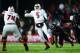 Dec 5, 2013; Cincinnati, OH, USA; Louisville Cardinals quarterback Teddy Bridgewater (5) scrambles out of the pocket and throws a pass for a touchdown during the fourth quarter against the Cincinnati Bearcats at Nippert Stadium. Mandatory Credit: Andrew Weber-USA TODAY Sports