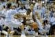 North Carolina's Nate Britt (0) and J.P. Tokoto guard UNC Wilmington's Addison Spruill during the first half of an NCAA college basketball game in Chapel Hill, N.C., Tuesday, Dec. 31, 2013. (AP Photo/Gerry Broome)